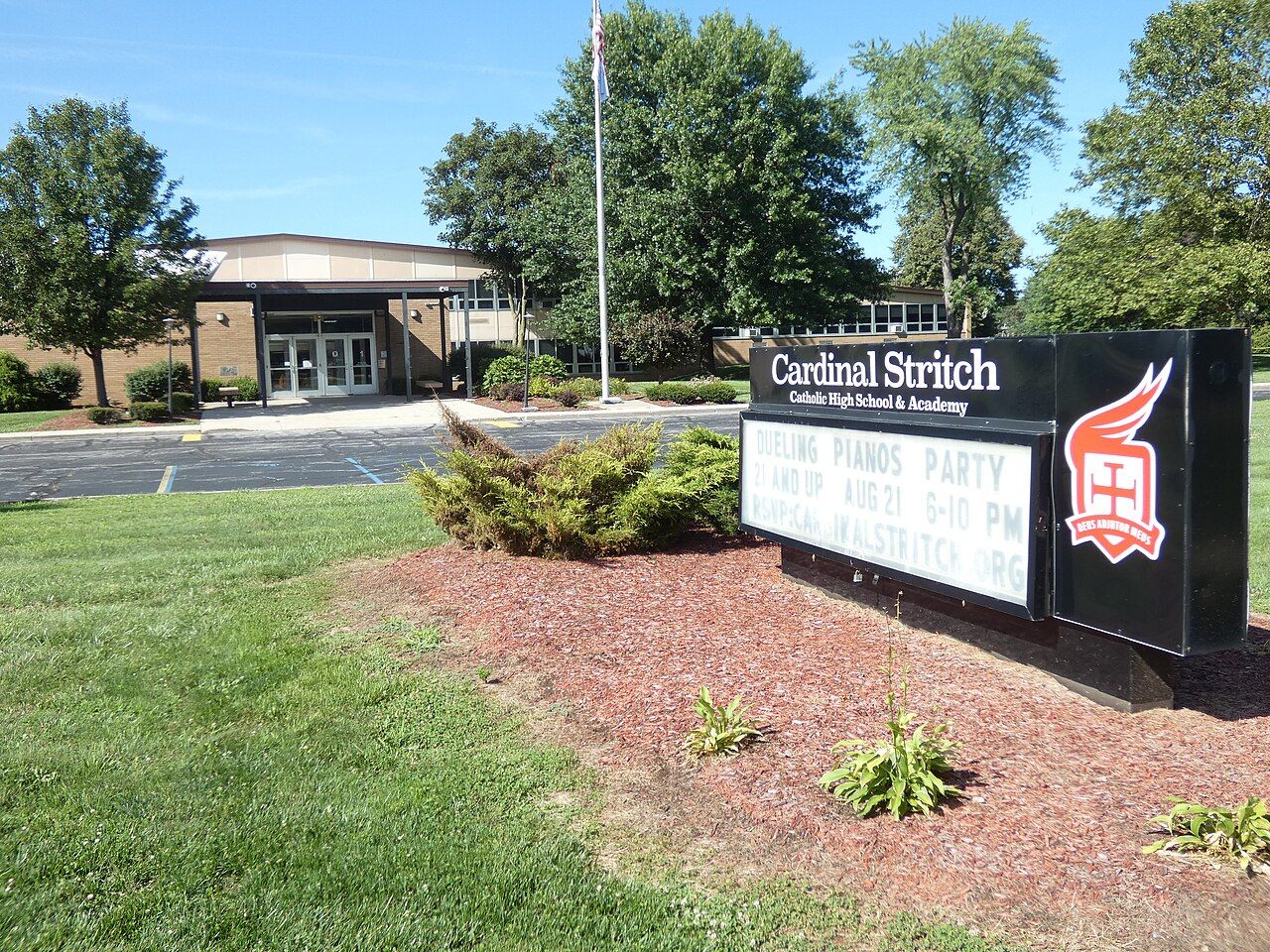 The main entrance of Cardinal Stritch Catholic High School in Oregon, Ohio, with the school's sign and marquee in the foreground / La entrada principal de Cardinal Stritch Catholic High School en Oregon, Ohio, con el letrero y la marquesina de la escuela en primer plano
